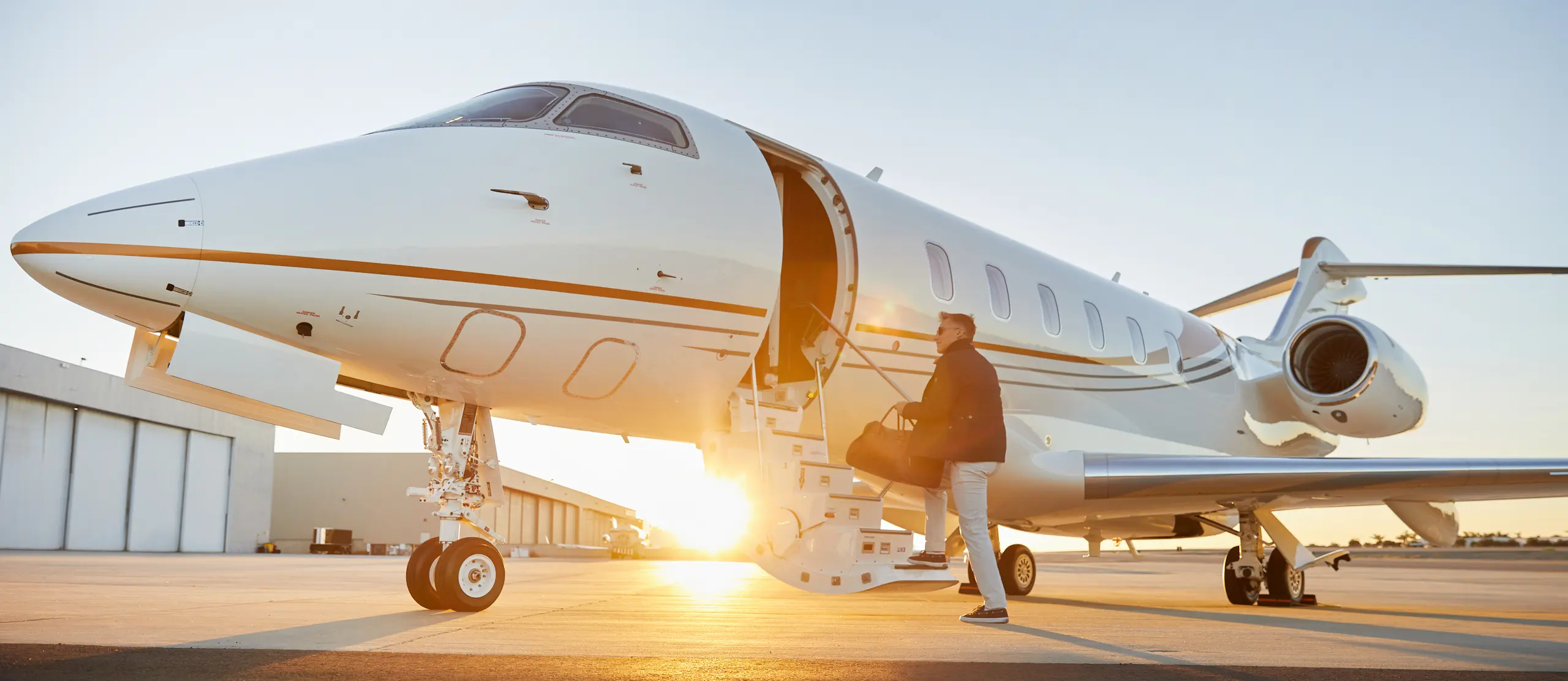 Boarding a private jet at sunset